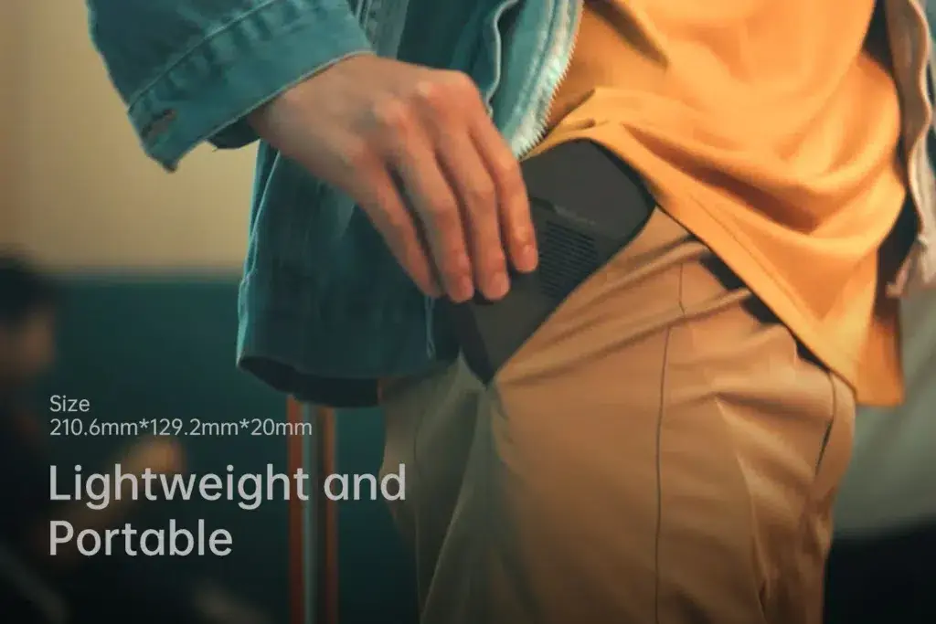 Close-up of the ONEXPLAYER X1 Mini being slipped into a pocket, showcasing its compact dimensions (210.6mm x 129.2mm x 20mm) and lightweight design.