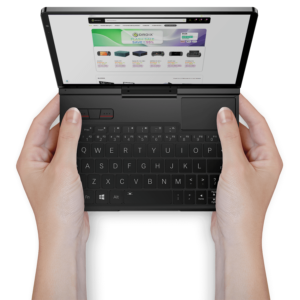 Hands holding the GPD Pocket 4 mini laptop, showcasing its portability and the compact keyboard layout, with a web page open on the screen.