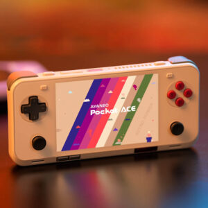 Retro beige AYANEO Pocket ACE on a table, lit warmly with its colorful screen displaying pixelated graphics and the Pocket ACE logo.