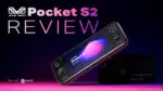 A dynamic thumbnail image for a video review of the AYANEO Pocket S2. The background is a gradient from dark purple to pink. A black AYANEO Pocket S2 handheld gaming console is angled in the center, with its screen displaying the logo "AYANEO Pocket S2" and a colorful abstract design. In the background, a second, blurred-out black console and a box are visible. Large white text in the upper left reads "Pocket S2 REVIEW", with the "AYANEO" logo above it. The bottom left corner has "BUY AT" followed by the white and green "DROIX" logo. The bottom right corner contains an asterisk and the text "the better option" in a small white font.