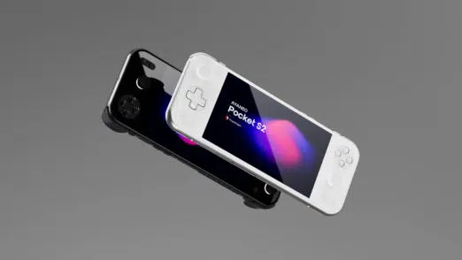 Two AYANEO Pocket S2 handheld gaming consoles, one black and one white, are shown at an angle against a solid grey background. The black console is positioned behind the white one, which is slightly elevated. Both screens display "AYANEO Pocket S2" with colorful abstract backgrounds. The white console's D-pad and face buttons are clearly visible.