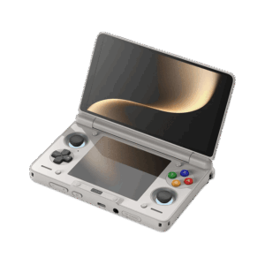 An angled, open view of a light grey AYN Thor handheld gaming console with a clamshell design, against a dark, featureless background. The top screen is open, displaying a soft golden abstract image. The bottom half of the device shows the controls, including a black D-pad, black analog sticks, and face buttons in red, blue, green, and yellow, resembling the classic "rainbow" controller aesthetic. Both the top and bottom screens are reflective, mirroring the golden light.
