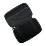 A top-down, angled shot of the black hard shell case for the GPD MicroPC 2, opened to reveal its interior. The top half of the case has a mesh pocket for accessories, while the bottom half has two elastic straps to securely hold the device. The case is empty.