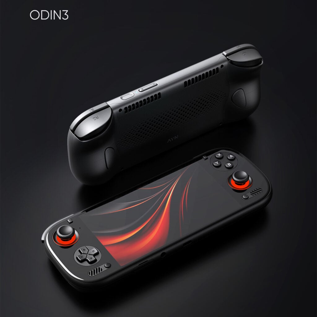 AYN Odin 3 Base, Pro, Max & ULTRA 1 A pair of black AYN ODIN3 handheld gaming consoles is shown against a dark, featureless background. The foreground console is face-up, with its screen displaying a vibrant red and black abstract design. Its joysticks are prominently lit with a glowing red ring. The second console is positioned behind and above it, flipped over to show the back of the device, which features a textured grip and ventilation grilles. The text "ODIN3" is in the top left corner.