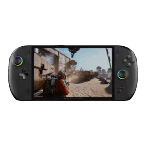 A sleek, black handheld gaming console, the ONEXPLAYER, is shown from a direct front-facing view against a solid white background. Key Visual Details: Screen: A large, vibrant display fills the center, showing a third-person shooter video game set in a dusty, industrial desert environment. A character in an orange suit is visible in the foreground. Controls: * Left Side: Features a circular joystick with a multi-colored RGB LED ring and a classic cross-shaped D-pad. Right Side: Features four action buttons (labeled X, Y, A, B), a second joystick with a matching RGB ring, and a dedicated "ONEX" button near the bottom. Design: The device has a rounded, ergonomic "pill" shape with a matte black finish. The "ONEXPLAYER" branding is subtly printed centered just below the screen.