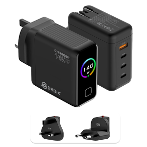 A detailed product graphic showing two views of the black DROIX 140W USB-C Wall Charger and its interchangeable international adapters. The top-left view displays the charger's matte black body with a glossy front screen. The display features a vibrant rainbow-colored circular ring around a "140 W" power indicator. The top-right view highlights the four output ports: three USB-C ports (labeled 40W, 100W, and 140W) and one orange USB-A port (22.5W). At the bottom, two snap-on travel adapters for UK and EU sockets are shown, highlighting the unit’s versatility for global travel.