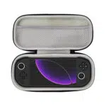 Open view of the MANGMI Pocket Max Carrying Case on a white background, demonstrating a snug fit with a black handheld gaming console nestled securely in the soft-lined bottom compartment. The screen displays a purple graphic, and the upper zippered mesh storage pocket is visible above it.