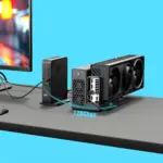 GPD BOX Mini PC front view with black ribbed case cabled to triple-fan PCIe eGPU, 120Gbps glow