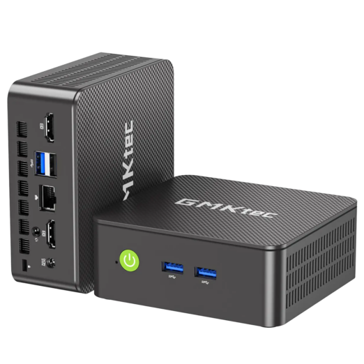 Two dark grey GMKtec mini PCs with textured top panels. One stands vertically to display rear ports, which include two HDMI p