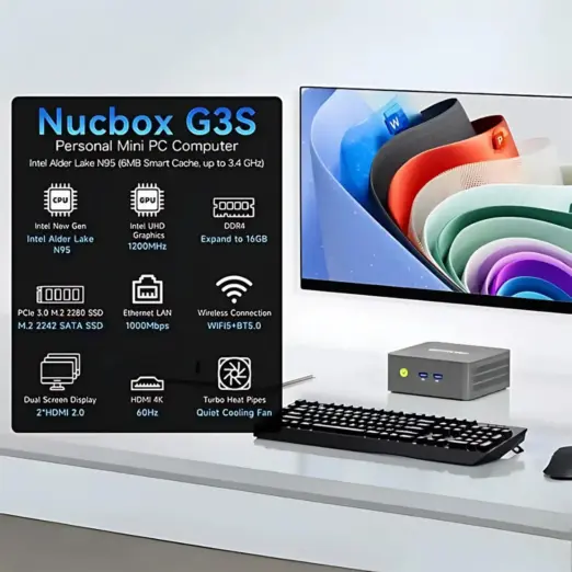 A lifestyle render of the Nucbox G3S mini PC situated on a white desk with a keyboard, mouse, and a monitor displaying an abs