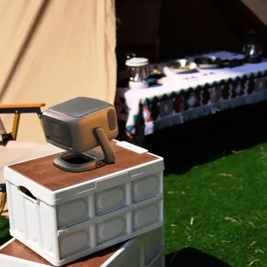 RockTek PJ500 Ultra 1080p smart projector in matte gray, angled on a white crate at a sunny campsite
